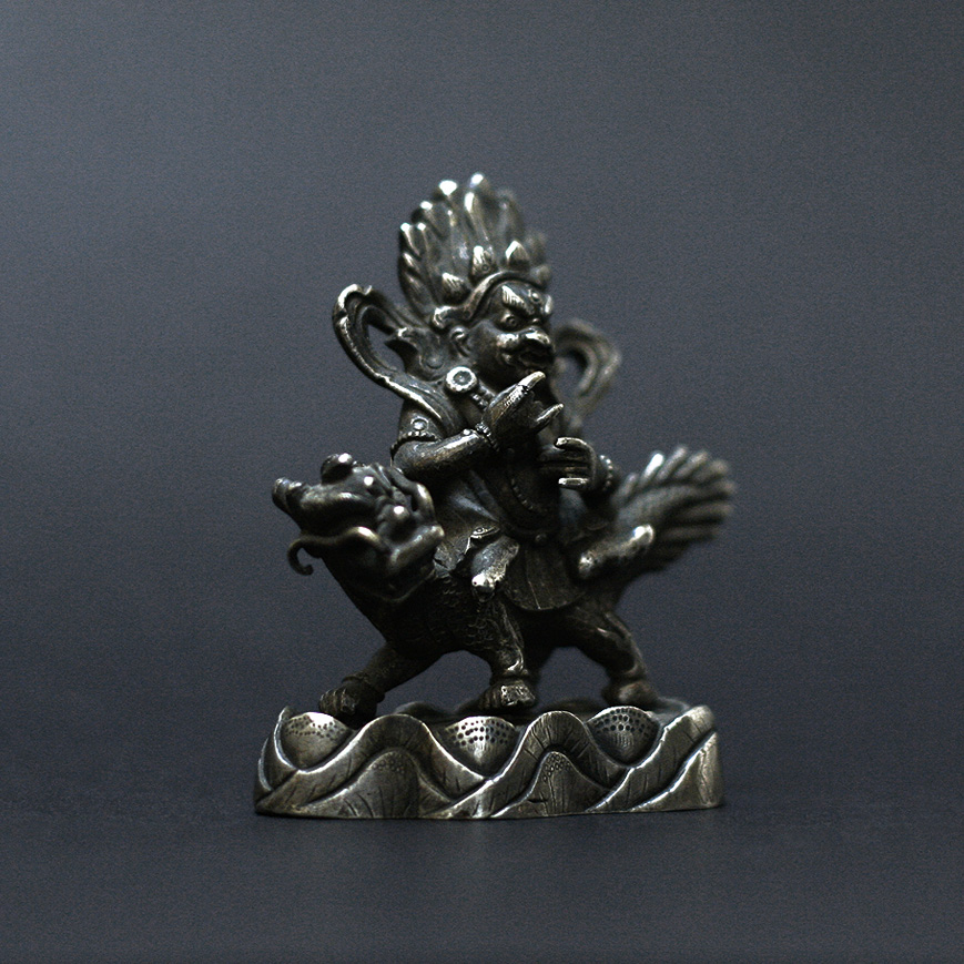 A JAMBHALA FIGURE IN SILVER ALLOY, TIBET 19TH