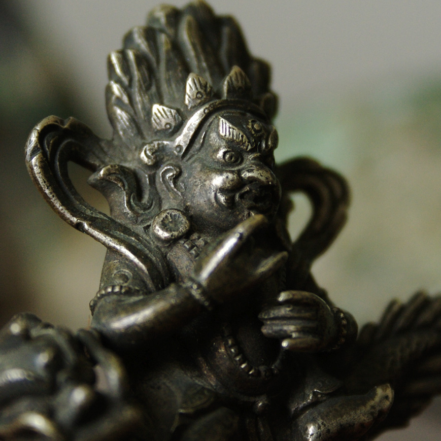 A JAMBHALA FIGURE IN SILVER ALLOY, TIBET 19TH