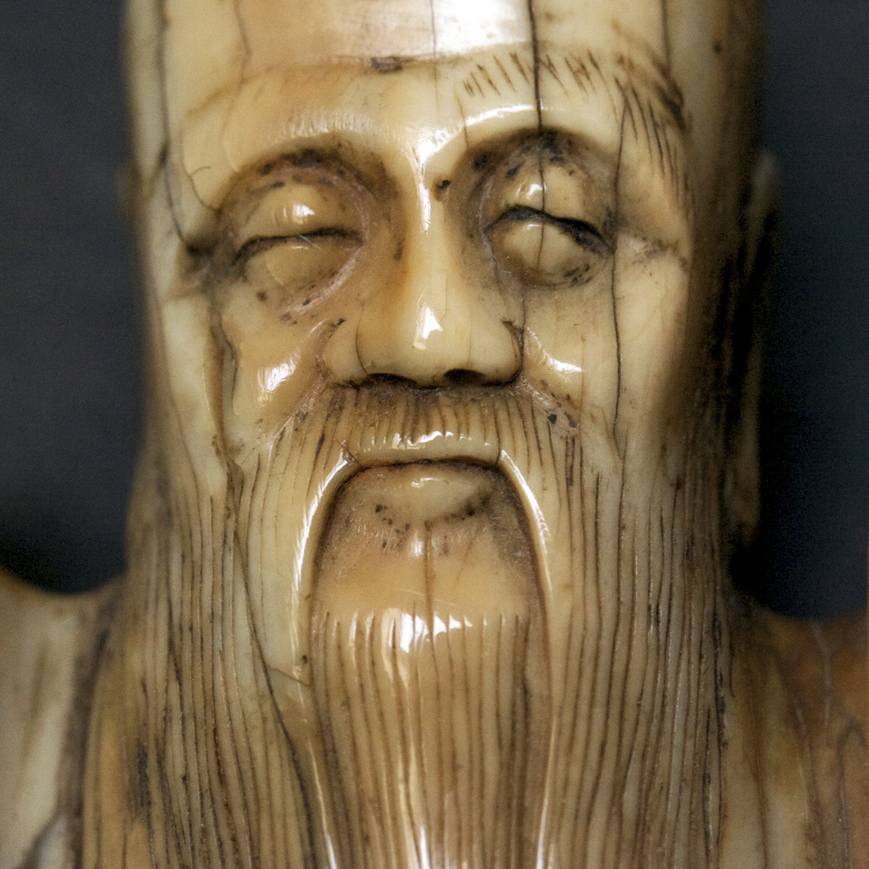 AN IVORY FIGURE OF AN IMMORTAL, MING DYNASTY-16TH CENTURY